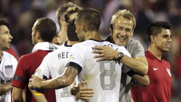 United States head coach Jurgen Klinsmann celebrates with Clint Dempsey (8) after their victory over Mexico in their 2014 World Cup qualifying soccer match in Columbus, Ohio September 10, 2013. REUTERS/Matt Sullivan (UNITED STATES - Tags: SPORT SOCCER)