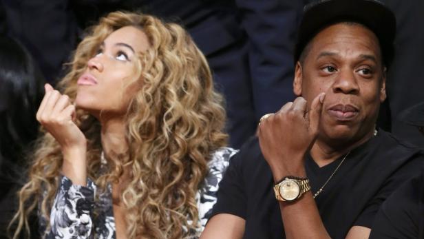 Singer Beyonce and her husband Jay-Z sit courtside before the NBA All-Star basketball game in Houston, Texas, February 17, 2013. REUTERS/Lucy Nicholson (UNITED STATES - Tags: SPORT BASKETBALL)