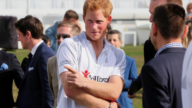 Britain&#039;s Prince Harry gestrues after competing in a charity polo match at Coworth Park, southern England August 3, 2013. REUTERS/Jane Mingay/Pool (BRITAIN - Tags: ENTERTAINMENT ROYALS SOCIETY SPORT)