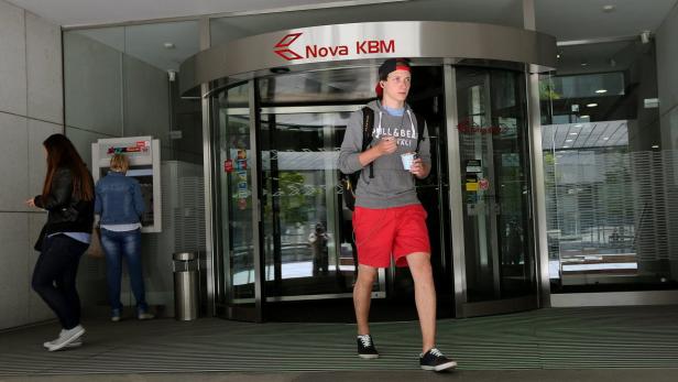 epa03713797 People walk in front of a branch of the NKBM bank in Maribor, Slovenia, 23 May 2013. The Slovenian government and labour unions on 14 May 2013 reached an agreement on wage cuts that aim to save more than 280 million euros (363 million dollars) over the next two years. Savings will be achieved by wage cuts, reduced government contributions for pensions, halved bonuses for academic titles and reduced sickness benefits, Interior and Public Administration Minister Gregor Virant said. The deal is expected to save 108.6 million euros in 2012 and 182.6 million euros in 2014, he said. It was &quot;the maximum that we could agree to and still preserve social peace,&quot; Virant said. Slovenia has been hit hard by the economic crisis and is struggling to cut spending to a sustainable level and thus to avert asking the European Union to bail it out. EPA/ANTONIO BAT