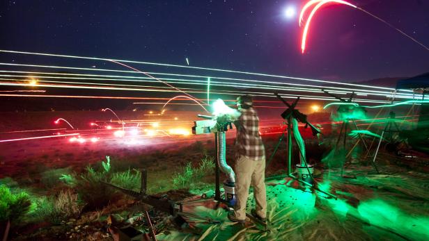 epa03478732 (16/22) A long exposure image shows a visitor to the Big Sandy Machine Gun Shoot firing his machine gun as flares, tracer fire, and the moon light up the night sky outside Wikieup, Arizona, USA, 19 October 2012. Twice a year, the Big Sandy lures gun enthusiasts to the Sonoran Desert for a weekend of firing heavy weaponry. EPA/JIM LO SCALZO PLEASE REFER TO ADVISORY NOTICE epa03478716 FOR FULL FEATURE TEXT
