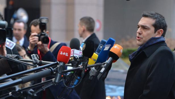 Alexis Tsipras spricht vor einer Wand aus Mikrofonen verschiedener Sender.