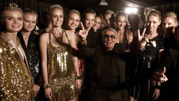 Italian designer Roberto Cavalli gestures together