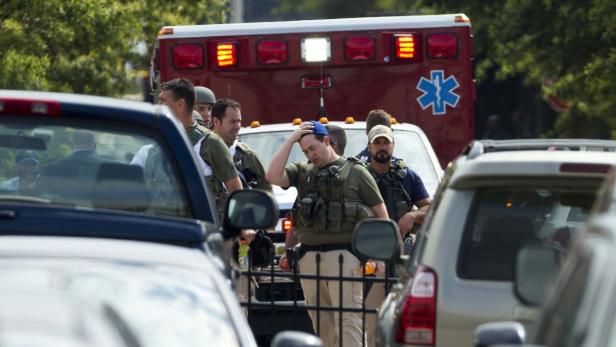 Heavily armed policemen walk from the Washington N