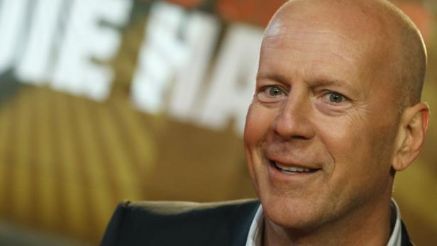 Actor Bruce Willis poses before the British premie