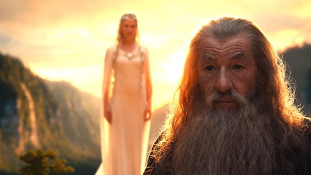 Gandalf und Galadriel in einer Szene aus „Der Herr der Ringe“ vor einer Bergkulisse.