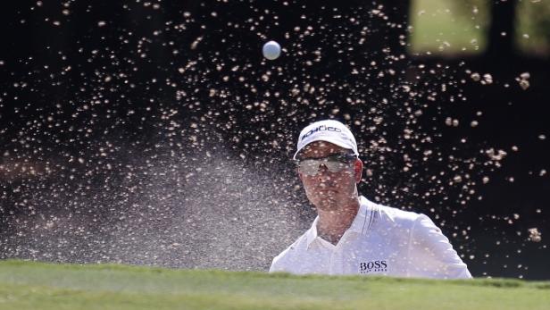 Henrik Stenson watches his shot from a sand trap o