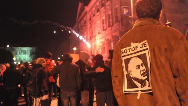 A protester wears a picture of Maribor&#039;s Mayor Franc Kangler, which reads: &quot;You are finished&quot;, during a demonstration in Maribor December 3, 2012. Protesters clashed with police in Slovenia&#039;s second largest city Maribor on Monday in a demonstration against budget cuts in the financially troubled Alpine state. Police said more than 20 people were arrested in Maribor and at least one policeman was injured after some from a crowd of around 6,000 protesters threw firecrackers, fireworks and rocks. Protesters were demanding the resignation of Kangler who has been accused of corruption. REUTERS/Srdjan Zivulovic (SLOVENIA - Tags: POLITICS CIVIL UNREST TPX IMAGES OF THE DAY)