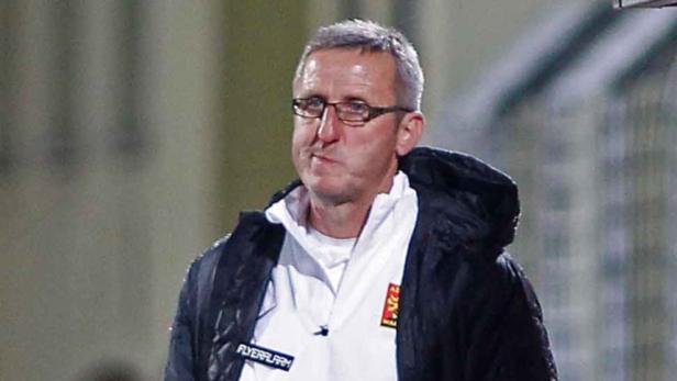 Ein Mann mit Brille und Jacke blickt nachdenklich zur Seite.