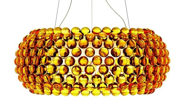 Eine Hängelampe aus vielen goldenen Kugeln vor einem weißen Hintergrund.