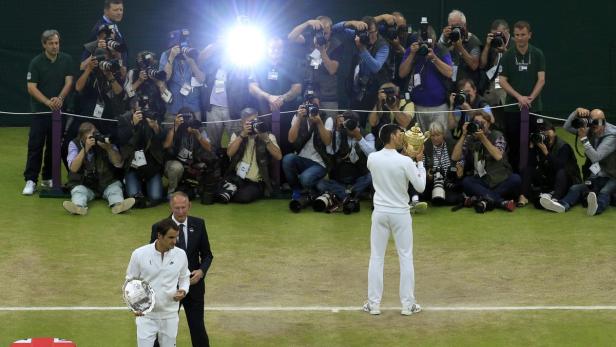 Novak Djokovic of Serbia kisses the trophy after w