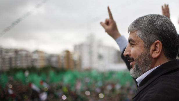 Hamas chief Khaled Meshaal gestures to the crowd during a rally marking the 25th anniversary of the founding of Hamas, in Gaza City December 8, 2012. Meshaal, making his first ever visit to the Gaza Strip, vowed on Saturday never to recognise Israel and said his Islamist group would never abandon its claim to all Israeli territory. REUTERS/Ahmed Jadallah (GAZA - Tags: POLITICS ANNIVERSARY CIVIL UNREST)