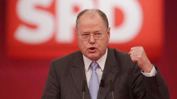 epa03502569 Peer Steinbrueck, the German Social Democratic Party SPD&#039;s chancellor candidate, speaks at the extraordinary SPD party convention at the fair ground in Hanover, Germany, 09 December 2012. Germany&#039;s largest opposition party SPD holds its congress this 09 December to anoint Peer Steinbrueck, a 65-year-old former finance minister, to challenge Angela Merkel at elections next year for the chancellorship. EPA/MICHAEL KAPPELER