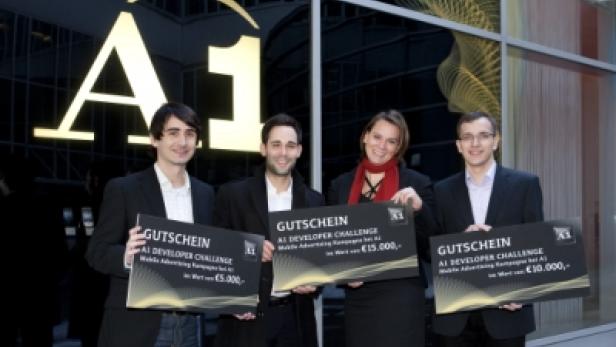 Vier Personen präsentieren Gutscheine der A1 Developer Challenge vor dem A1-Logo.