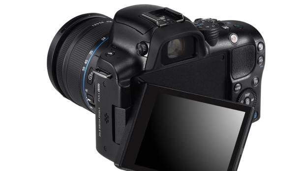 Eine schwarze Spiegelreflexkamera mit ausgeklapptem Display und Objektiv ist zu sehen.