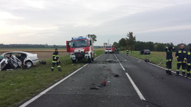 Nach einem Autounfall sind Feuerwehrleute und -fahrzeuge im Einsatz.