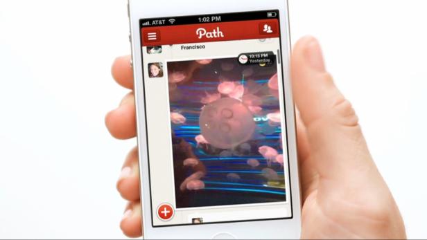Ein Handy zeigt einen Screenshot der Path-App mit einem Foto von Quallen.