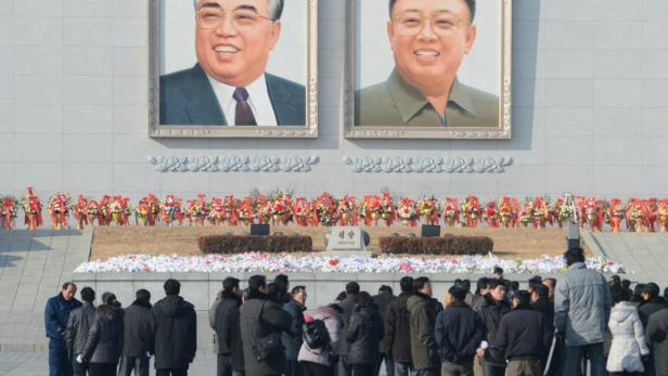 North Koreans offer flowers at the Kim Il Sung square in Pyongyang, on the first anniversary of Kim Jong-il&#039;s death, in this photo taken by Kyodo December 17, 2012. Mandatory Credit REUTERS/Kyodo (NORTH KOREA - Tags: ANNIVERSARY POLITICS) FOR EDITORIAL USE ONLY. NOT FOR SALE FOR MARKETING OR ADVERTISING CAMPAIGNS. THIS IMAGE HAS BEEN SUPPLIED BY A THIRD PARTY. IT IS DISTRIBUTED, EXACTLY AS RECEIVED BY REUTERS, AS A SERVICE TO CLIENTS. MANDATORY CREDIT. JAPAN OUT. NO COMMERCIAL OR EDITORIAL SALES IN JAPAN. YES