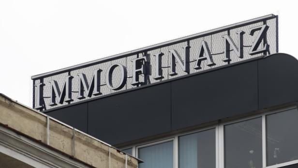 The logo of Austrian property group Immofinanz is pictured on the rooftop of an office building in Vienna March 21, 2013. Immofinanz said it would continue to expand on the German housing market in preparation for an initial public offering of its Buwog residential unit which is likely next year, while scaling back development elsewhere. REUTERS/Heinz-Peter Bader (AUSTRIA - Tags: BUSINESS)