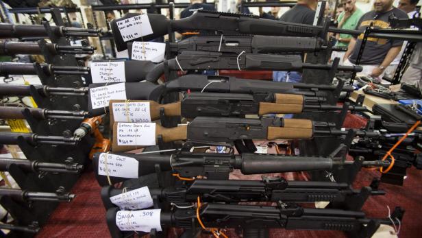 epa03323085 Shotguns and semi-automatic rifles were among the weapons on display for sale at The Nation&#039;s Gun Show held in the Dulles Expo Center in Chantilly, Virginia, USA, 28 July 2012. Gun sales have risen in the U.S. in the wake of the movie theatre shooting massacre in Aurora, Colorado on 20 July. EPA/JIM LO SCALZO