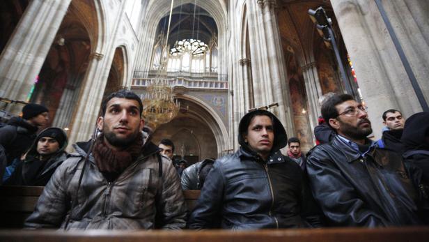 Eine Gruppe von Männern sitzt in einer Kirche.