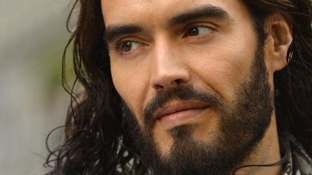 British actor and comedian Russell Brand arrives for the European premiere of the film Rock of Ages at Leicester Square in central London in this June 10, 2012 file photograph. Brand faced up to six months in prison on July 25, 2012, when he was charged with a misdemeanor in New Orleans for throwing a photographer&#039;s iPhone through a window. REUTERS/Toby Melville/Files (BRITAIN - Tags: ENTERTAINMENT HEADSHOT CRIME LAW)