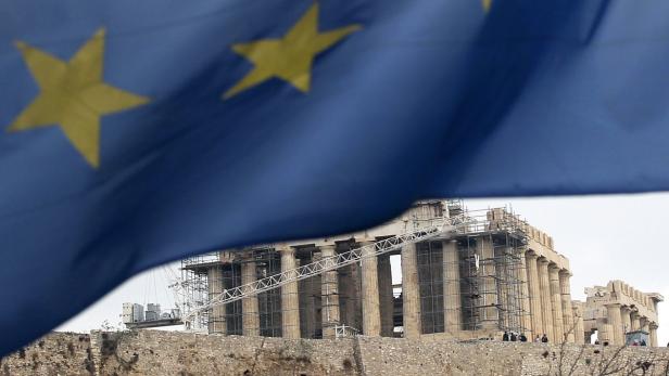 epa03487959 The flag of European Union waves with the Parthenon of Athens&#039; Acropolis on background, 27 November 2012. Financial markets gave a cautiously optimistic welcome to a Greek debt deal unveiled in Brussels 27 November, with markets across the continent registering modest upticks. But the deal remains incomplete until it receives approval from a gauntlet of national European parliaments in the coming weeks. German lawmakers are expected to vote on the agreement on 29 November. Parliaments in the Netherlands and Estonia are also likely to consider the plan, a key component of which would provide the cash-strapped nation with a next tranche of aid totalling 43.7 billion euros (56.6 billion dollars). EPA/ORESTIS PANAGIOTOU