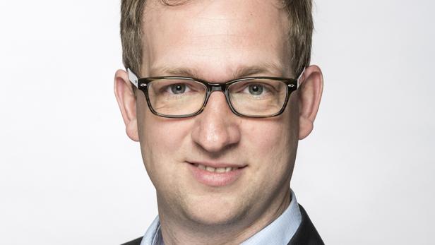 Ein Mann mit Brille lächelt in die Kamera.
