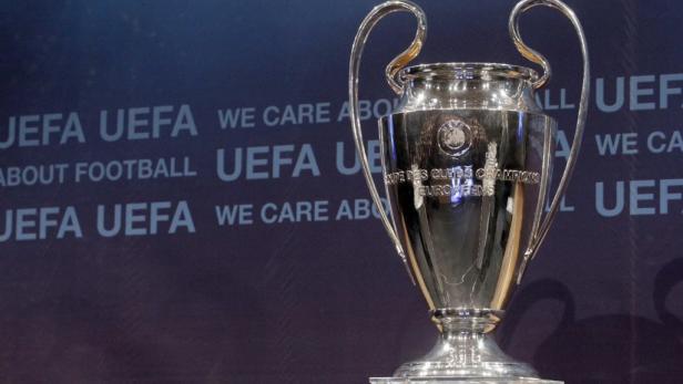 Die Trophäe der UEFA Champions League vor einem Hintergrund mit dem UEFA-Logo.
