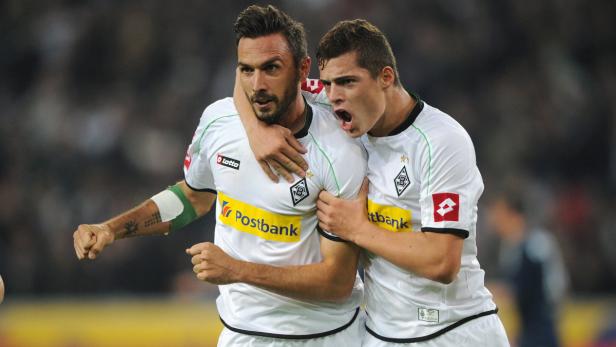 epa03411517 Moenchengladbach&#039;s Martin Stranzl (L) celebrates his 1:1 goal with team mate Granit Xhaka (R), during the German Bundesliga match between Borussia Moenchengladbach and Hamburger SV at Borussia Park in Moenchengladbach, Germany, 26 September 2012. (ATTENTION: EMBARGO CONDITIONS! The DFL permits the further utilisation of up to 15 pictures only (no sequntial pictures or video-similar series of pictures allowed) via the internet and online media during the match (including halftime), taken from inside the stadium and/or prior to the start of the match. The DFL permits the unrestricted transmission of digitised recordings during the match exclusively for internal editorial processing only (e.g. via picture picture databases). EPA/JONAS GUETTLER