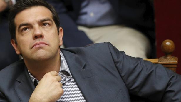Greek Prime Minister Alexis Tsipras reacts during