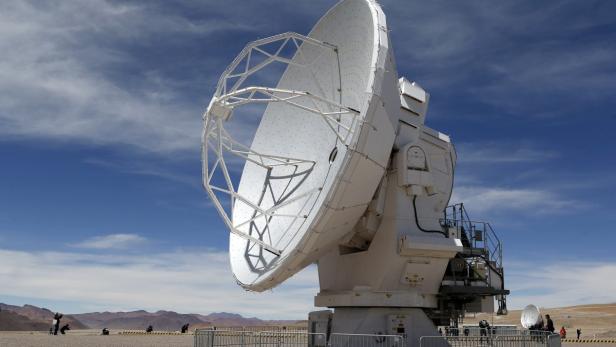 A parabolic antenna of the ALMA (Atacama Large Millimetre/Submillimetre Array) project is seen at the El Llano de Chajnantor in the Atacama desert, some 1730 km (1074 miles) north of Santiago and 5000 metres above sea level, March 12, 2013. ALMA will be inaugurated on Wednesday and is being constructed by the ESO (European Organisation for Astronomical Research in the Southern Hemisphere) with its partners NAOJ (National Astronomical Observatory of Japan) and NRAO (National Radio Astronomy Observatory). ALMA will have 66 high precision antennas which will work together as a single giant telescope to study the universe, molecular gas, dust of stars, galaxies and planetary systems, ESO said. REUTERS/Ivan Alvarado (CHILE - Tags: SCIENCE TECHNOLOGY ENVIRONMENT)