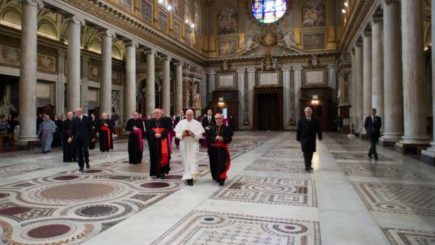 Newly elected Pope Francis I (C), Cardinal Jorge Mario Bergoglio of Argentina, walks in the 5th-century Basilica of Santa Maria Maggiore during a private visit in Rome March 14, 2013. Pope Francis, barely 12 hours after his election, quietly left the Vatican early on Thursday to pray for guidance as he looks to usher a Roman Catholic Church mired in intrigue and scandal into a new age of simplicity and humility. REUTERS/Osservatore Romano (ITALY - Tags: RELIGION)