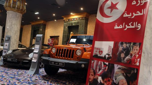 epa03516923 Luxury cars that once belonged to the family of ousted Tunisian president Zine el-Abidine Ben Ali, are on display at an auction in the Gammarth suburb of Tunis,Tunisia, 23 December 2012. The exhibition contains of 22 luxury cars, about 300 pieces of jewelry and nearly 12,000 other pieces, including luxury bags, watches, clothing, furniture, paintings and antiques. Ben Ali and his family fled the country in January 2011 after being ousted following several month of civil uprising in Tunisia. EPA/MOHAMED MESSARA