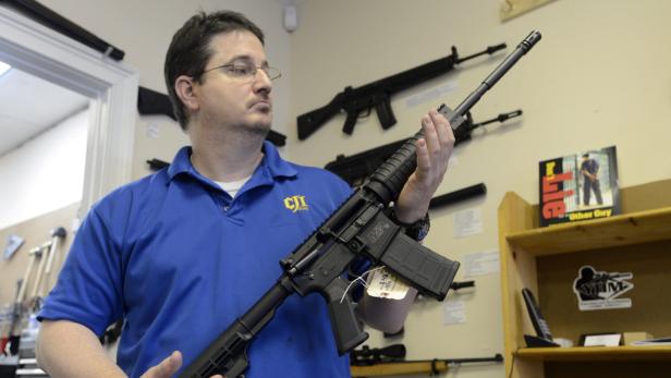 epa03514348 Ron Moon, co-owner of CJI Guns, holds a Smith &amp; Wesson MP15 assault style semi-automatic rifle at his gun store in Tucker, Georgia, USA, 19 December 2012. The rifle is the same AR-15 style weapon used in the Connecticut school shooting. US President Barack Obama is to deliver remarks at the White House on 19 December on policies to address gun violence, just days after a mass shooting at a Connecticut elementary school. Obama is expected to name Vice President Joe Biden to lead a task force to examine potential tougher gun laws and other measures. Earlier in the week, Obama met with Biden and several Cabinet secretaries to address possible action. The killings in Newtown of 20 children aged 6 and 7, along with six adults in a school and the gunman&#039;s mother have led to a national debate on US gun laws and mental health care. EPA/ERIK S. LESSER