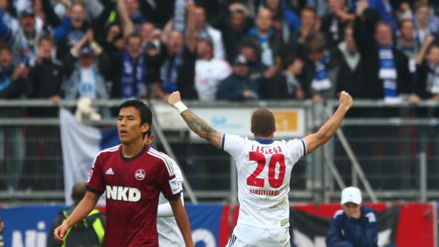 Ein Fußballspieler mit der Nummer 20 jubelt vor einer jubelnden Zuschauermenge.