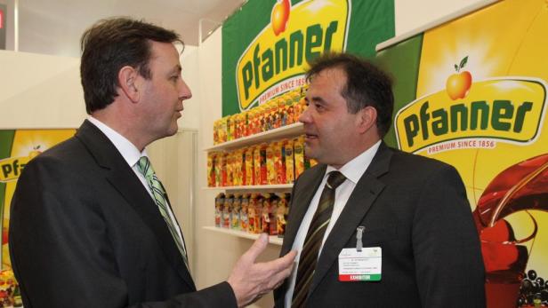 Zwei Männer unterhalten sich vor einem Stand der Firma Pfanner.