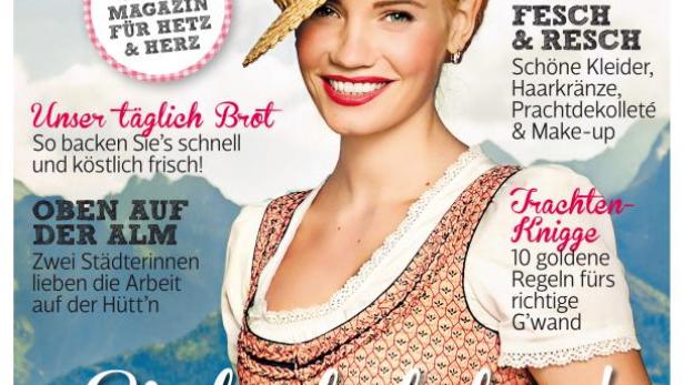 Das Cover der Zeitschrift „Woman Dirndl“ mit einer lächelnden Frau im Dirndl und Strohhut.