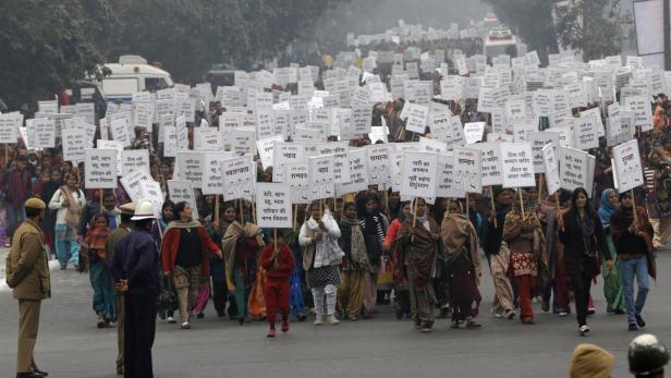 Women hold placards as they march during a rally organized by Delhi Chief Minister Sheila Dikshit (unseen) protesting for justice and security for women, in New Delhi January 2, 2013. The ashes of the Indian student who died after being gang-raped were scattered in the Ganges river on Tuesday as reports of more attacks stoked a growing national debate on violence against women. The death of the 23-year-old woman, who has not been named, prompted street protests across India, international outrage and promises from the government of tougher punishments for offenders. REUTERS/Adnan Abidi (INDIA - Tags: CRIME LAW CIVIL UNREST POLITICS TPX IMAGES OF THE DAY)