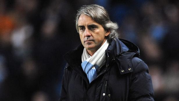 epa03521929 Manager of Manchester City Roberto Mancini during the English Premier League soccer match between Manchester City and Stoke City at the Etihad Stadium, Manchester, Britain, 01 January 2013. EPA/DAVID RICHARDS DataCo terms and conditions apply. http//www.epa.eu/downloads/DataCo-TCs.pdf