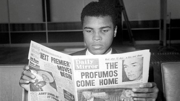 Cassius Clay (later Muhammad Ali) reads the newsp