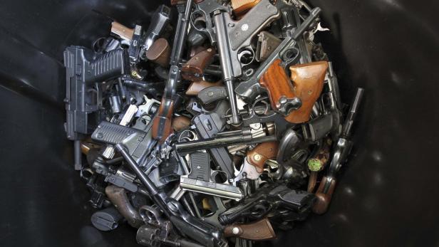 Hand guns that were turned in by their owners are seen in a trash bin at a gun buyback held by the Los Angeles Police Department following the mass shooting at Sandy Hook Elementary School in Connecticut, in Los Angeles, California, December 26, 2012. The program normally occurs in May but Los Angeles mayor Antonio Villaraigosa accelerated the schedule in response to the December 14 shooting that left 20 children and six adults dead, along with the gunman, and caused a national outcry against gun violence. People can anonymously trade in their guns, no questions asked, for $200 grocery store gift cards for automatic weapons and $100 gift cards for shotguns, handguns and rifles. REUTERS/David McNew (UNITED STATES - Tags: SOCIETY)
