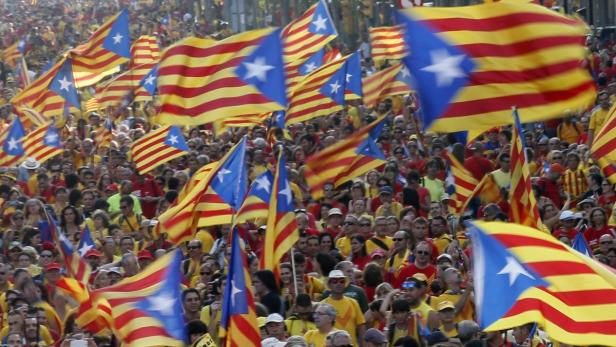 People hold "estelada" flags, Catalan separatist f