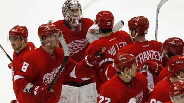 Detroit Red Wings goalie Jimmy Howard (C) celebrates with teammates after shutting out the Edmonton Oilers during their NHL hockey game in Detroit, Michigan March 7, 2013. REUTERS/Rebecca Cook (UNITED STATES - Tags: SPORT ICE HOCKEY)