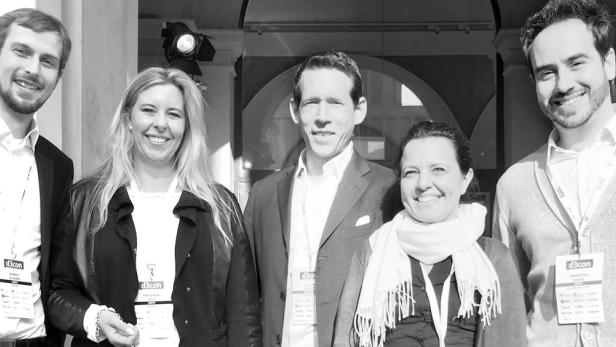 Eine Gruppe von fünf Personen posiert für ein Foto, alle tragen Namensschilder von d3con.