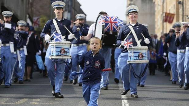 A boy marches with a flute band during a pro-Union