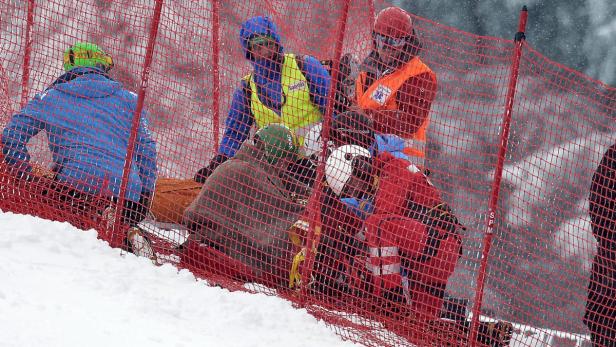 epa03623694 Klaus Kroell of Austria is rescued after crashing during the men&#039;s Super G race of the Alpine Skiing World Cup finals in Parpan - Lenzerheide, Switzerland, 14 March 2013. EPA/PETER SCHNEIDER