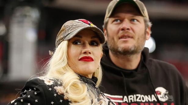 Gwen Stefani und Blake Shelton tragen Arizona Cardinals-Mützen.