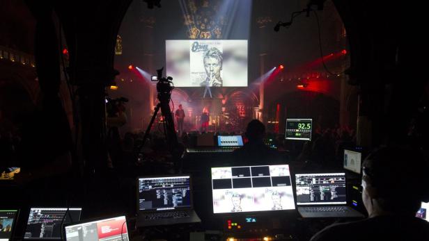 An image of British music legend David Bowie is seen from the control room during a tribute evening to him in London, on January 17, 2016. David Bowie&#039;s music dominated the weekly British charts out on January 15, commanding a quarter of the top 40 albums as mourning fans rushed to buy his music. The Londoner, who died from cancer aged 69 on January 10, had 19 albums in the top 100 and 13 entries in the top 100 singles, ranging from songs dating from the 1960s to tracks off his new album. AFP PHOTO / JUSTIN TALLIS