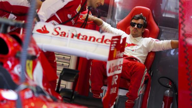 epa03802046 Spanish Formula One driver Fernando Alonso of Scuderia Ferrari sits in his team&#039;s garage during the first practice session at the Hungaroring race track in Mogyorod near Budapest, Hungary, 26 July 2013. The 2013 Hungarian Formula One Grand Prix will take place on 28 July. EPA/VALDRIN XHEMAJ